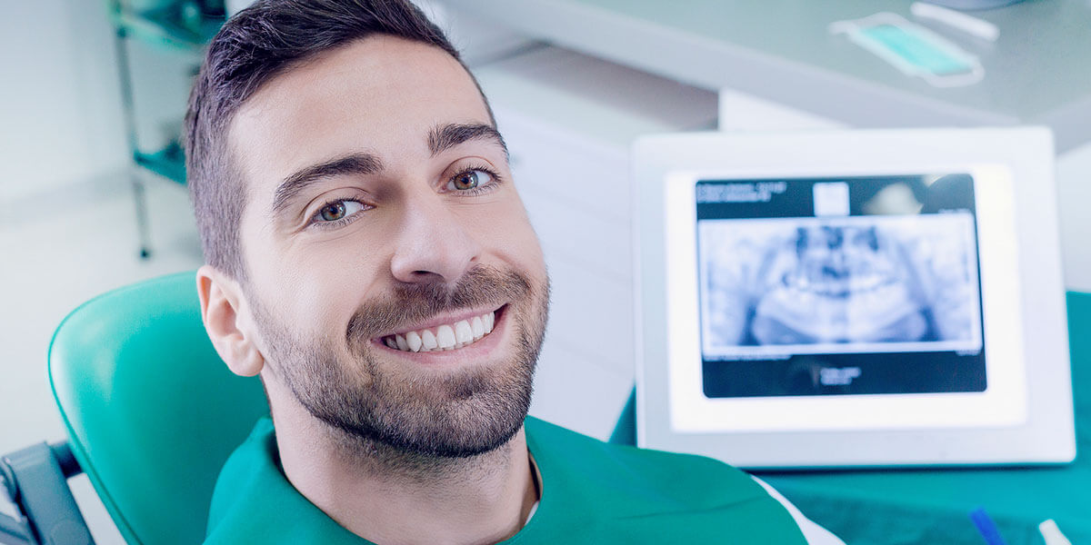 Smiling Male Patient with Xray In Background